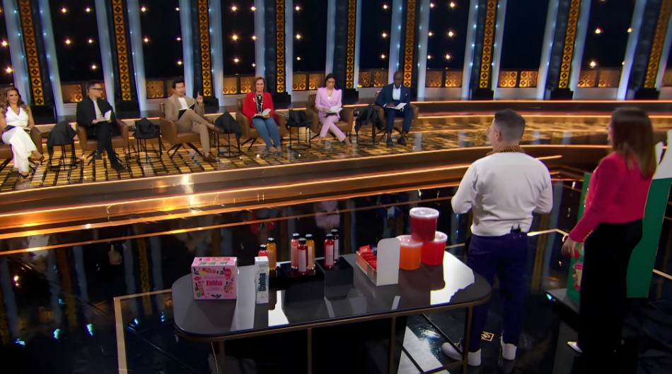 Judges and contestants gather in a studio setting