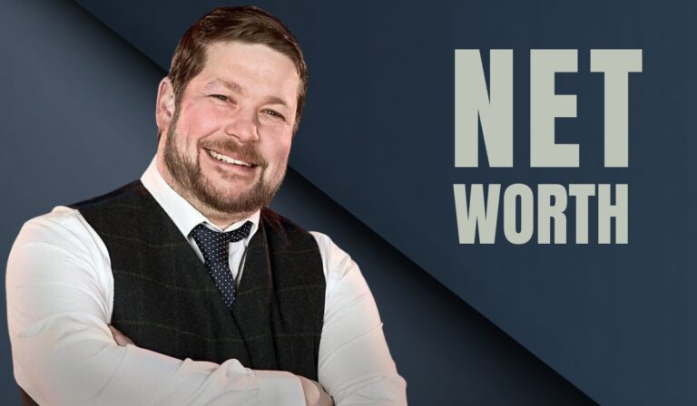 Smiling man in a vest and tie standing with arms crossed beside the words "Net Worth" on a dark blue background