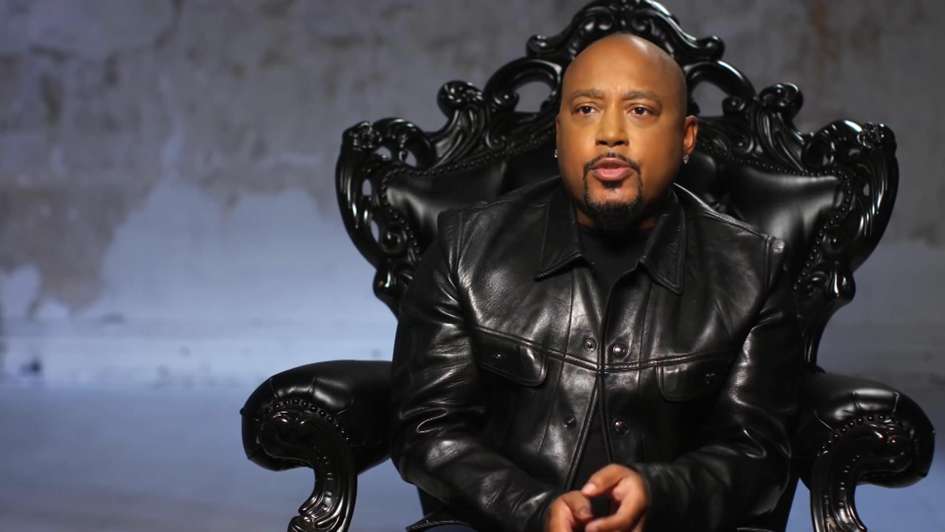 Entrepreneur seated in an ornate black chair during an interview.