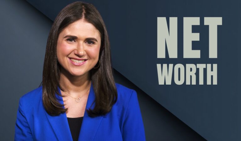 Smiling woman in a blue blazer with "Net Worth" text in the background
