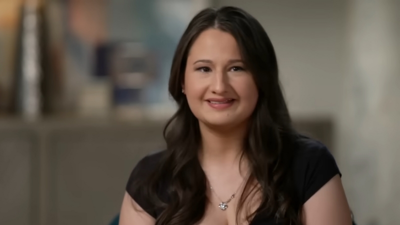 Gypsy Rose smiling in an interview, wearing a black top and a silver necklace