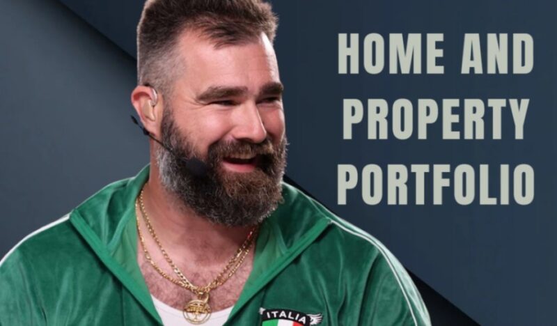 A close-up of Jason Kelce smiling while wearing a green velour jacket and gold chains