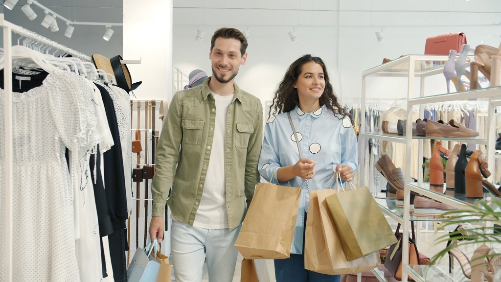 Bright and well-organized boutique interior with clothing racks, shoes on display, and open walking space
