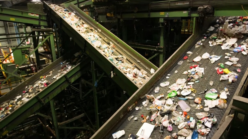 Conveyor belts move mixed waste through a facility for garbage recycling
