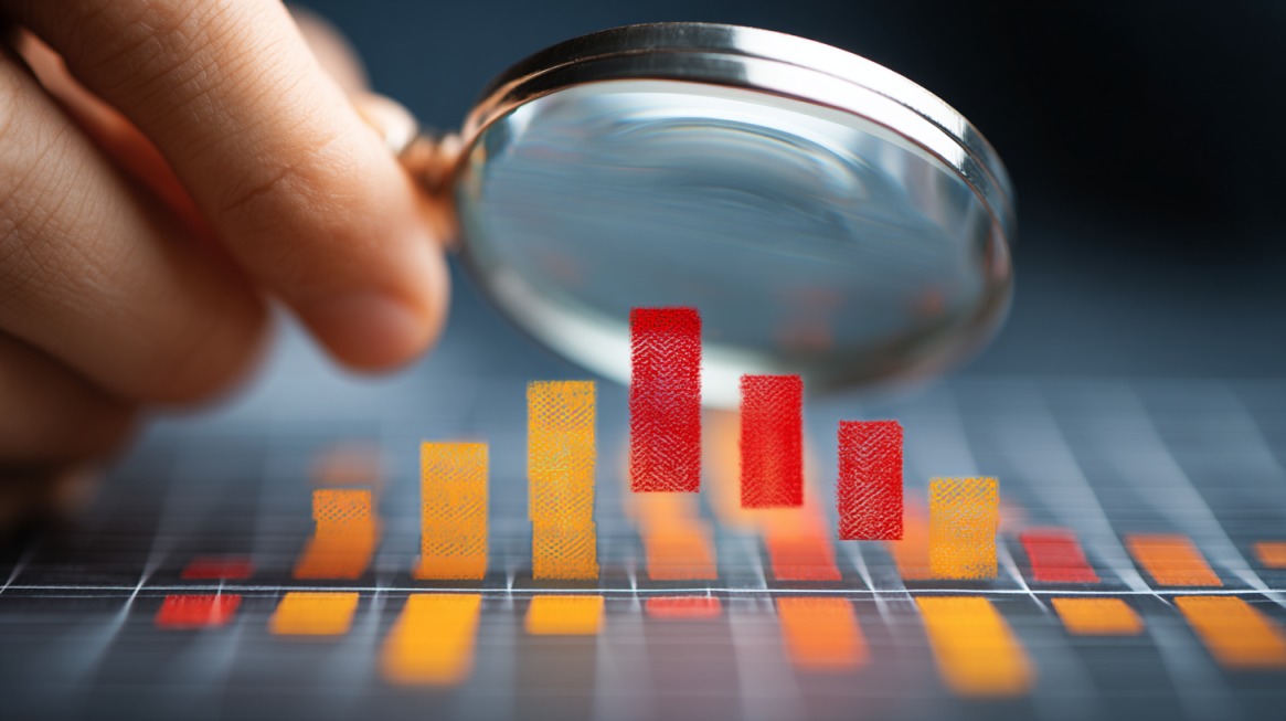 Magnifying glass analyzing a colorful bar chart on a screen