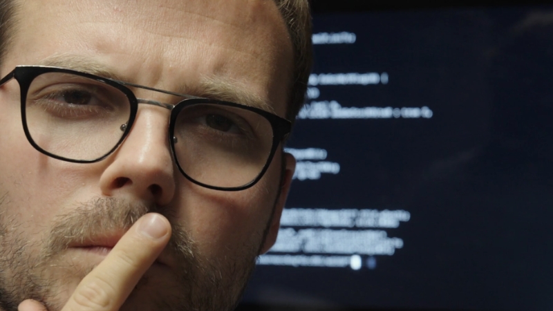 Person in front of a screen with code and text, representin AI based learning and training platforms
