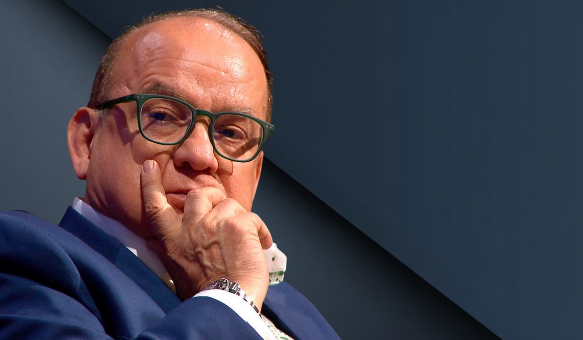 A close-up portrait of Touker Suleyman resting his chin on his hand with a thoughtful expression