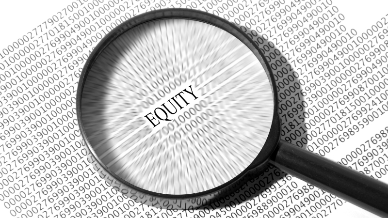 Magnifying glass focusing on the word “Equity” over a background of numbers