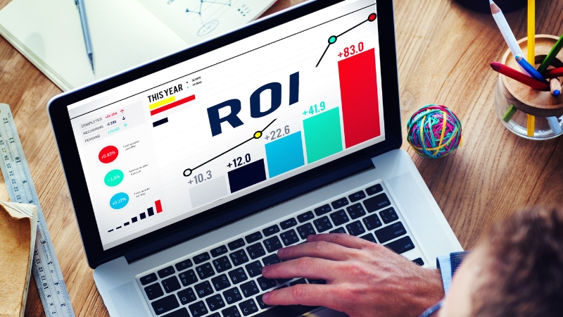 Laptop screen displaying a marketing ROI chart with rising performance bars