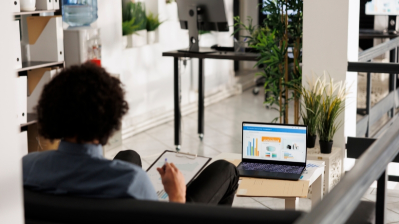 Person reviewing marketing performance charts on a laptop to plan budget allocation