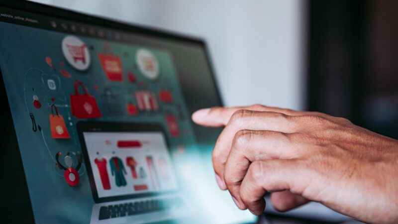 Person interacting with an online store showing personalized product recommendations on a screen