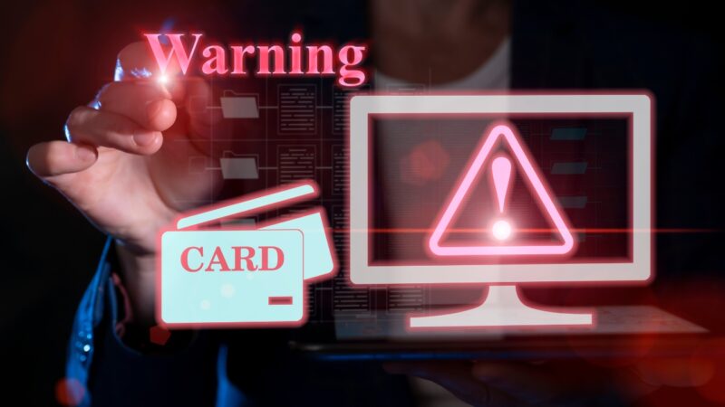A card fraud alert appears beside a laptop screen