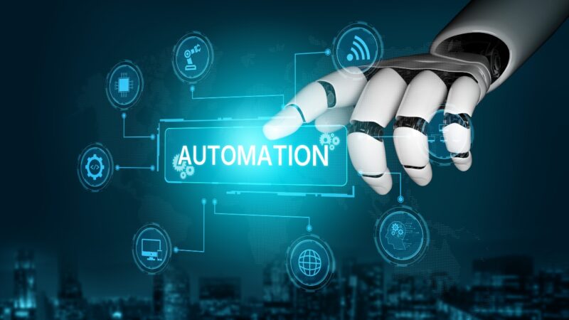 A robotic hand taps an automation dashboard on a digital screen