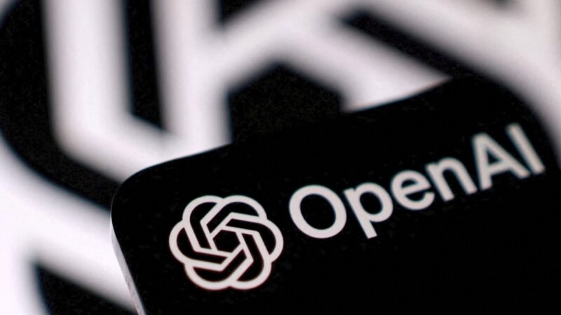 Close-up of the OpenAI logo on a black surface